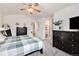 Comfortable main bedroom featuring plush carpet, ceiling fan, and modern decor at 23813 Broadmoor Dr, Parker, CO 80138