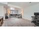 Finished basement featuring gray carpet, neutral walls, and a comfortable sectional sofa for relaxation and entertainment at 14798 E Temple Dr, Aurora, CO 80015