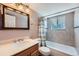 Well-lit bathroom featuring stylish fixtures, decorative mirror, and a shower-tub combination for a relaxing experience at 14798 E Temple Dr, Aurora, CO 80015