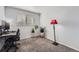 Neutral bedroom featuring a desk, plants, blinds, and a distinctive red lamp at 14798 E Temple Dr, Aurora, CO 80015