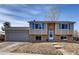 Charming two-story home with brick accents, blue shutters and attached garage, offering classic curb appeal at 14798 E Temple Dr, Aurora, CO 80015
