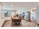 Bright kitchen features white cabinetry, stainless steel appliances, and a cozy dining area with wood table at 14798 E Temple Dr, Aurora, CO 80015