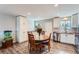 Kitchen with a dining table, stainless steel appliances, and white cabinets at 14798 E Temple Dr, Aurora, CO 80015