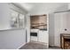 Convenient laundry area with modern washer and dryer, plenty of storage space, and natural light from a nearby window at 14798 E Temple Dr, Aurora, CO 80015
