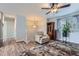 Bright living room with hardwood floors, comfortable seating, and a ceiling fan at 14798 E Temple Dr, Aurora, CO 80015