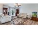 Cozy living room features hardwood floors, a leafy rug, and ample natural light at 14798 E Temple Dr, Aurora, CO 80015