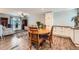 Open layout connecting the kitchen, dining, and living spaces, all featuring matching hardwood floors at 14798 E Temple Dr, Aurora, CO 80015