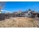 Spacious backyard featuring a shed, a dog run, mature tree, and solar panels on the roof at 865 S Dale Ct, Denver, CO 80219
