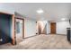 Finished basement with neutral carpet, multiple doors, stairs, and ample space at 865 S Dale Ct, Denver, CO 80219