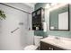 Well-lit bathroom with a shower, sleek vanity, modern fixtures, and plants for ambiance at 865 S Dale Ct, Denver, CO 80219