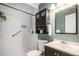 Updated bathroom with shower, toilet, vanity, and dark-wood cabinet and mirror at 865 S Dale Ct, Denver, CO 80219