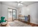 Bedroom features a crib, a large rug, and walk in closet with sliding door at 865 S Dale Ct, Denver, CO 80219