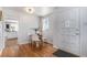 Bright dining room with hardwood floors, a cozy table setting, and white walls at 865 S Dale Ct, Denver, CO 80219