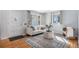 Bright living room showcasing hardwood floors, a comfortable sofa, and ample natural light at 865 S Dale Ct, Denver, CO 80219