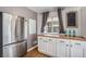 Stylish pantry featuring a stainless steel refrigerator and dark wood countertop space at 865 S Dale Ct, Denver, CO 80219