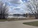 Scenic pond view with a walking path, serene water reflections, and mature trees at 865 S Dale Ct, Denver, CO 80219