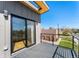 Outdoor balcony featuring gray composite decking, black railings, and views of the neighborhood at 1385 N King St, Denver, CO 80204