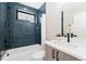 Stylish bathroom featuring blue tiled shower, modern vanity and matte black fixtures at 1385 N King St, Denver, CO 80204