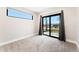 Bright bedroom with sliding doors, large window and plush carpet floors at 1385 N King St, Denver, CO 80204
