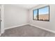 Bright bedroom featuring gray carpet, white trim and a large window allowing ample natural light at 1385 N King St, Denver, CO 80204