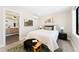 Cozy bedroom with modern décor, a green rug, and an ensuite bathroom at 1385 N King St, Denver, CO 80204