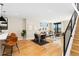 Open-concept dining area featuring hardwood floors, modern lighting, and a view of the living room at 1385 N King St, Denver, CO 80204