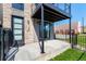 Modern townhome entrance featuring stone accents, black trim, and a private outdoor patio at 1385 N King St, Denver, CO 80204