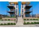 Modern townhomes with stone accents, private balconies, and well-manicured landscaping leading to unit entrances at 1385 N King St, Denver, CO 80204