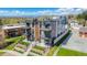 Modern townhome with gray siding, stone accents, and balconies in a landscaped community with mountain views at 1385 N King St, Denver, CO 80204