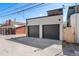 Two-car detached garage with gray doors, set against a clear blue sky in a modern style at 1385 N King St, Denver, CO 80204