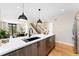 Open kitchen featuring an island, stainless steel appliances, and hardwood floors at 1385 N King St, Denver, CO 80204