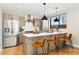 Contemporary kitchen with a center island, stainless steel refrigerator, and breakfast bar seating at 1385 N King St, Denver, CO 80204