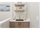 Stylish wet bar featuring floating shelves, mosaic backsplash, and modern fixtures at 1385 N King St, Denver, CO 80204