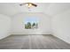 Spacious bedroom with vaulted ceiling, ceiling fan, neutral carpet, and a large window providing natural light at 2253 Coronado Pkyn # D, Denver, CO 80229