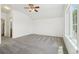Bright bedroom featuring neutral carpet, a ceiling fan, and a window that offers great natural lighting at 2253 Coronado Pkyn # D, Denver, CO 80229