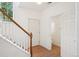 Welcoming entryway with a staircase, front door, and a view into the downstairs bathroom at 2253 Coronado Pkyn # D, Denver, CO 80229