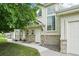 Charming townhome with stone accents, lush landscaping, and multiple windows at 2253 Coronado Pkyn # D, Denver, CO 80229