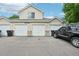 Exterior view of townhouse featuring multiple garage doors at 2253 Coronado Pkyn # D, Denver, CO 80229