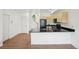 Stylish kitchen with dark countertops, modern cabinets, and a view of the staircase at 2253 Coronado Pkyn # D, Denver, CO 80229