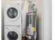 Laundry area featuring a washer and dryer plus a water heater at 2253 Coronado Pkyn # D, Denver, CO 80229