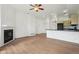 Open-concept living space with a fireplace, wood floors, and a seamless flow to the kitchen at 2253 Coronado Pkyn # D, Denver, CO 80229