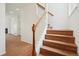 Elegant staircase with wood and white railing, connecting the home's floors at 2253 Coronado Pkyn # D, Denver, CO 80229