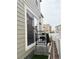 A cozy backyard features a small porch, garden beds, and a white fence, perfect for outdoor relaxation at 5126 Buckwheat Rd, Brighton, CO 80640