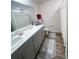 Bathroom with a stylish vanity, plush rugs, and modern fixtures offers a tranquil retreat at 5126 Buckwheat Rd, Brighton, CO 80640