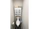 Cozy powder room with neutral paint, toilet, and a storage cabinet for toiletries and towels at 5126 Buckwheat Rd, Brighton, CO 80640