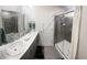 Large bathroom featuring a double vanity, sliding glass shower door and a private toilet at 5126 Buckwheat Rd, Brighton, CO 80640