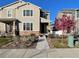 Charming two-story home with stone accents, landscaped front yard, and flowering tree at 5126 Buckwheat Rd, Brighton, CO 80640