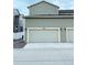 A spacious three-car garage with modern doors provides ample parking and storage, adding convenience at 5126 Buckwheat Rd, Brighton, CO 80640