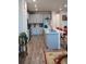 Open kitchen with gray cabinetry, quartz countertops, stainless steel appliances, and wood flooring at 5126 Buckwheat Rd, Brighton, CO 80640
