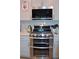 Modern kitchen features stainless steel range and microwave, plus granite countertops at 5126 Buckwheat Rd, Brighton, CO 80640
